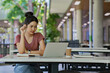 © mojo_cp - Young university student woman using laptop doing assays research