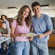 © Miljan Živković - male and female student read notes from notebook in the library