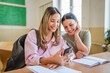 © Miljan Živković - high school female students use phone in class to text message