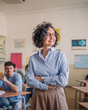 © Miljan Živković - A mature female teacher stand confidently in her elementary classroom