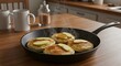 © Mike Ebony - A sizzling skillet of apple cinnamon pancakes with maple syrup on a kitchen table