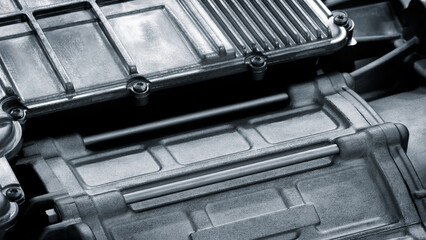 Aufkleber - A close up of a car engine with a black and silver color scheme. The engine is made of metal and has a shiny appearance