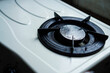 © Pernandi Imanuddin - Close-up capturing the subtle details of a gas stove burner, displaying its circular form and metallic texture, ideal for kitchen design and appliance promotional material usage.
