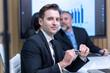 © unikyluckk - Diverse Team Working Together in Modern Co-Working Space. Casual meeting of smiling diverse business team analyzing financial data. Multiethnic business people working together in the office.