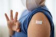 © Art_Photo - Asian boy making an OK hand gesture after vaccination with bandage on arm, child health care, hospital service, influenza vaccine protection, covid prevention, pediatric safety immunity booster