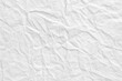 © Celt Studio - White crumpled paper surface with random wrinkles and folds creating organic textured background perfect for vintage stationery mockup design