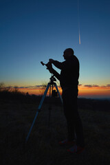 Wall Mural - amateur astronomer using telescope for watching stars, moon, planets and other celestial objects fro