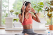 © weedezign - young healthy asian woman listening music while practice yoga at home