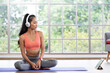 © weedezign - young healthy asian woman listening music while practice yoga at home