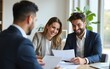© zhao - Happy couple reading terms of  agreement during  meeting with bank manager in office. High quality