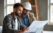 © wang - Mid adult man and building contractor examining housing plans on laptop at construction site. High quality