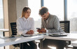 © standret - Cooperation, working on project. Man and woman are indoors in modern building