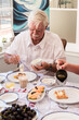 © Austockphoto - senior man enjoying brunch on xmas morning