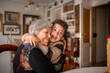 © GREGORIO - Grandson hugging grandmother at home showing love and affection