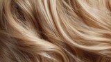 Close-up of long, flowing, light blonde hair with gentle waves and subtle highlights, showcasing its smooth texture and healthy shine
