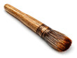 © SMURFFYx - A realistic close-up shot of a paintbrush with natural bristles and a wooden handle, isolated on a white background