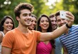 © MR RIHAD - Group of young adults taking a selfie and smiling in a park setting