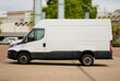 © I am from Mykolayiv - Long Wheelbase White Delivery Van Driving Through Business District