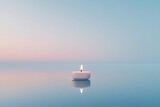 Single candle reflecting on still water, soft pastel colors