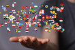 © vegefox.com - Image of diverse flags floating above a hand, symbolizing global connections and international collaboration.