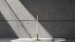 © svonidze - Single burning candle on a concrete background