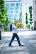 © gzorgz - Confident man walking on the city street and using his phone