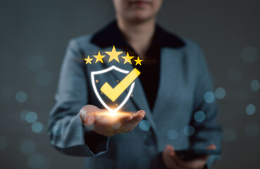 Poster - Quality Assurance and Compliance Certification Concept. Businesswoman presents glow shield icon with checkmark and five stars, symbolizing quality assurance, certification, and compliance verification