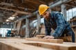 © Oleg - Skilled carpenter measuring wood in a workshop during the daytime