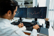 © InfiniteFlow - Smart trader businessman analyzing in two dynamic stock exchange investment screen on pc with investing highest profitable financial technology in searching market at modern home office. Surmise.
