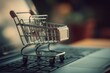 © serdon - The concept of online shopping or home shopping is represented by a shopping cart or trolley on a laptop keyboard, symbolizing the e-commerce experience of buying goods and services from home