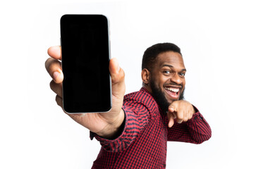 Wall Mural - great app. african man showing phone blank screen recommending new mobile application posing over wh