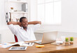 © Prostock-studio - Successful business. Relaxed black businessman in casual with laptop in modern white office interior. Lifestyle portrait