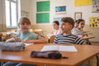 © Miljan Živković - school girl and boy pupil sit in school class in the classroom