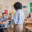 © Miljan Živković - Back view of professor talk about lecture to high school students