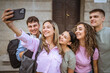 © Miljan Živković - group of happy classmates take a self portrait and in front of school