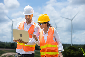 Fototapete - man and women engineer worker wind turbine handshake success agreement survey discuss operational planning. Windmill field clean energy sustainable clean. engineering nature power alternative.