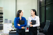 © laddawan - Two Asian businesswoman and man discuss investment project working and planning strategy