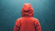 © pingpao - A person in a red raincoat stands in the rain, facing away under a dark, moody sky.