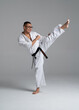© oscar - Kyokushinkai karate fighter performing a high kick in studio
