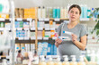 © JackF - Adult pregnant woman is interested in choosing an ointment for stretch marks in a pharmacy.