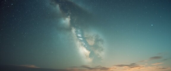 Aufkleber - Milky Way illuminates a serene landscape at dawn, with clouds and stars, creating a celestial panorama