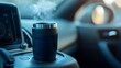 © Ounseng - Car cup holder with a steaming travel mug