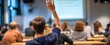 © Studio Nova - The engaged student raising hand in a bustling educational classroom setting.