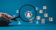 © Helen - Magnifying glass highlighting a target and a man icon on a blue background. Customer recognition and searching. Talent acquisition.