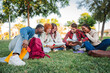 © Jose Calsina - Dynamic group of enthusiastic students sharing ideas and collaborating on their studies in an outdoor setting, fostering friendship and teamwork while enjoying each other's company and learning.