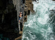 © Westend61 - Climber tackling a challenging deep water solo route on a cliff in Pembrokeshire, Wales