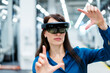 © Westend61 - Businesswoman with augmented reality eyeglasses making finger frame at industry