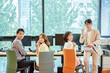 © Dialogue Frame - Young Asian Men and Women Team Working Together in Modern Office