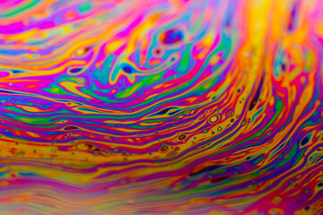 Vivid swirling colors on soap film macro textures