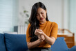 © Parichat - Asian woman massaging her painful wrist at home, suffering from arthritis, carpal tunnel syndrome or other joint disease